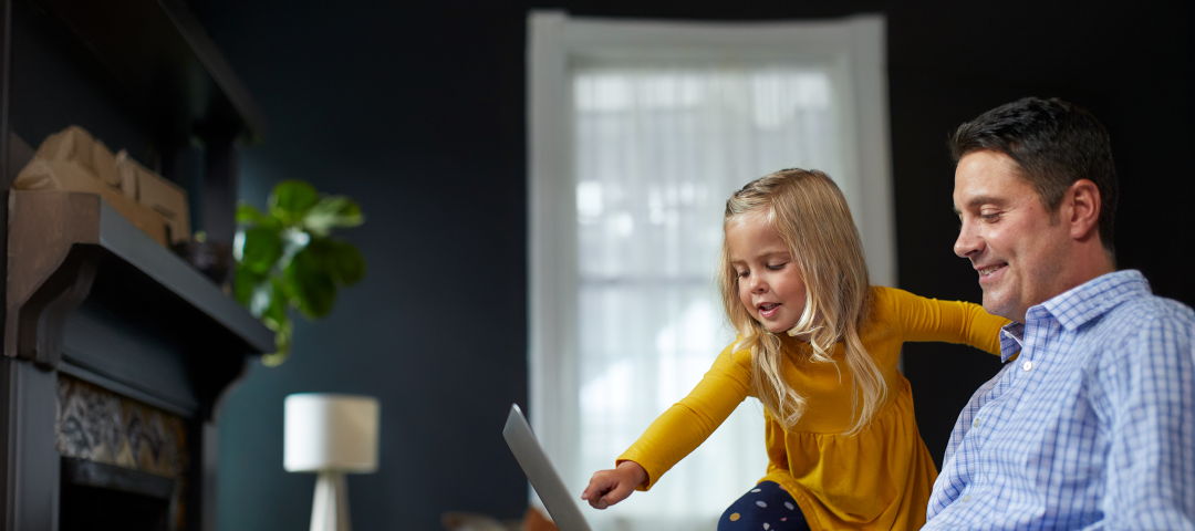 Father and Daughter Pointing to Laptop