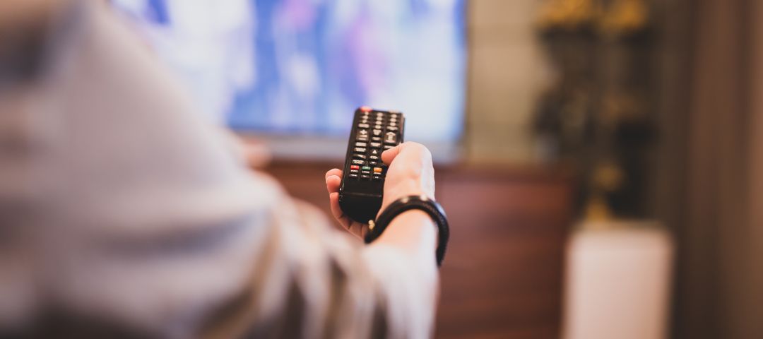 Hand Holding Remote to TV
