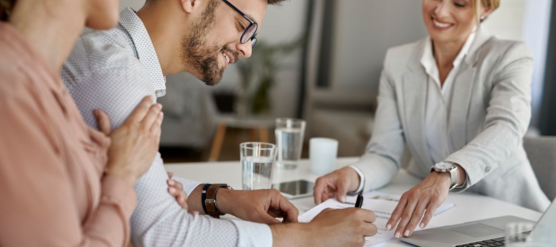 Three People Meeting at a Desk