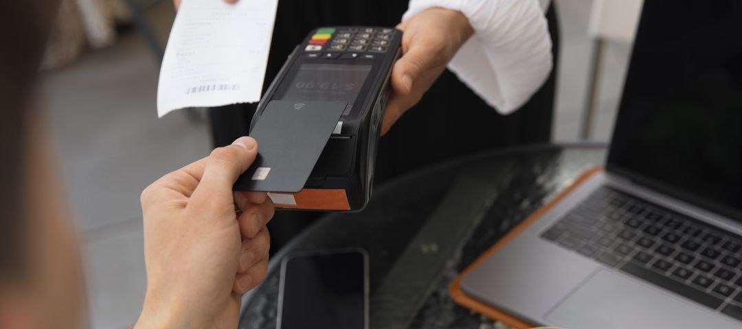Customer Paying with POS Machine at Table