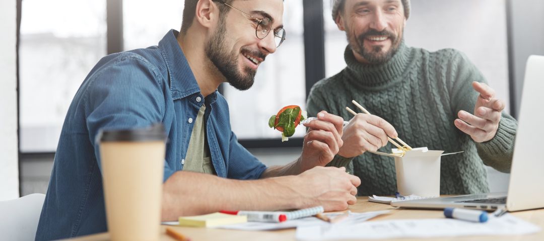 Male Couple Eating Lunch and Choosing Plans
