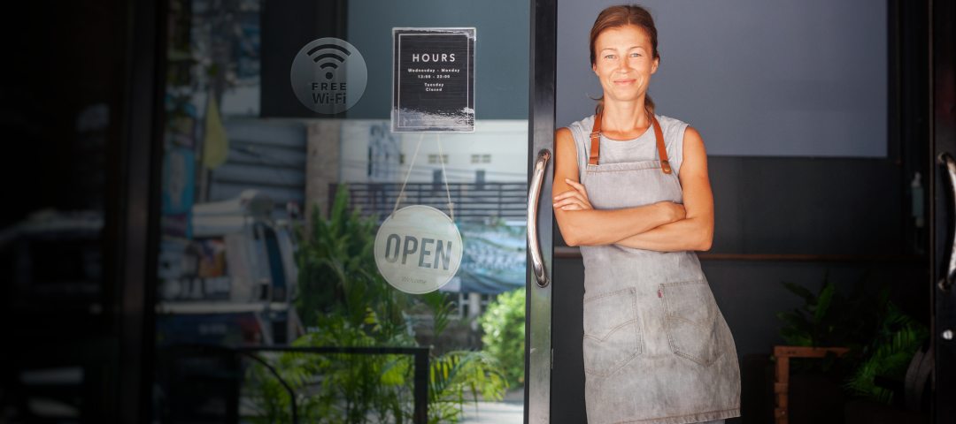 Woman Standing at the Door of her Business
