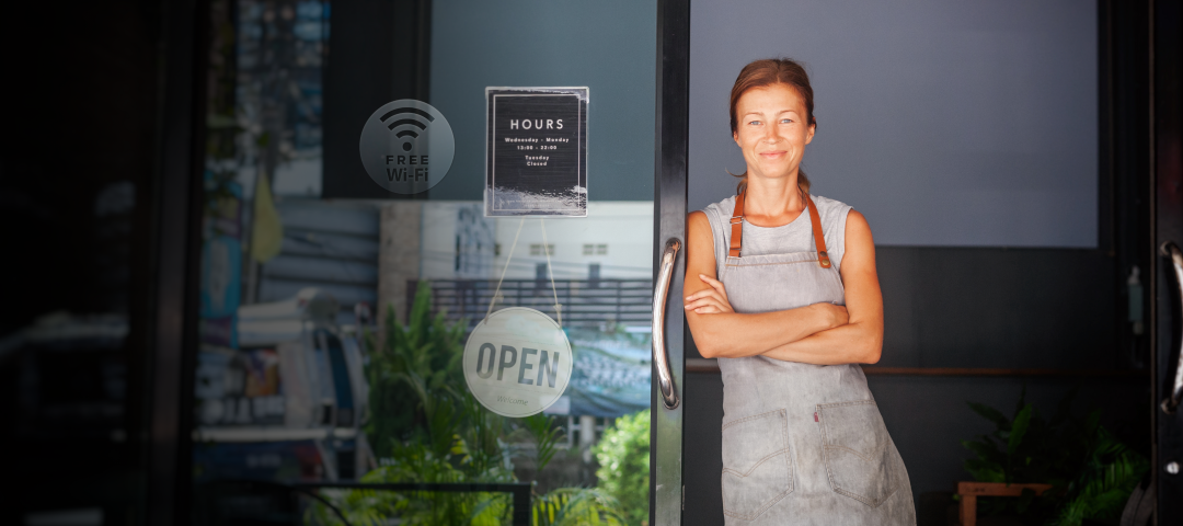 Woman Standing at the Door of her Business