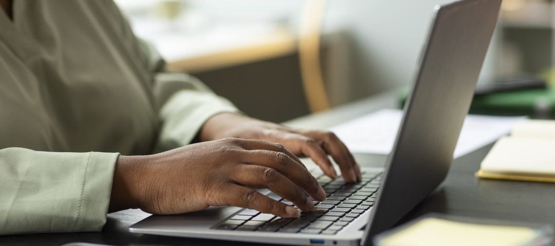 Hands Using a Laptop